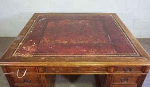 A George III style mahogany partners desk, early 20th century, with a wide leathered and moulded