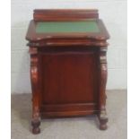 A Victorian style reproduction Davenport desk, with sloped front, and four side drawers and carved