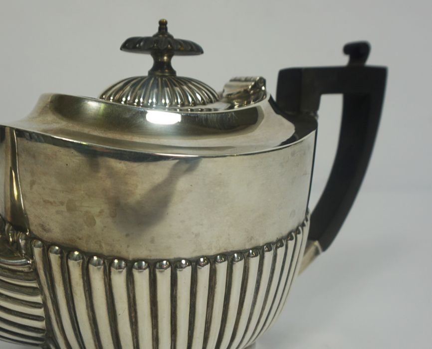 An Edwardian silver teapot, hallmarked Sheffield 1905, of oval part fluted form, with ebonized - Image 4 of 6