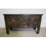 A 17th century oak coffer, with lozenge carved front and stile feet, with later alterations, 74cm