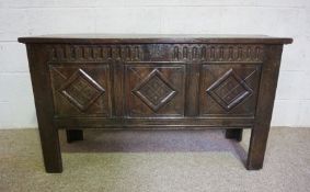 A 17th century oak coffer, with lozenge carved front and stile feet, with later alterations, 74cm