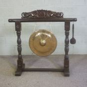 A Chinese gong and stand, with a hardwood carved stand, and suspended brass 43cm diameter gong,