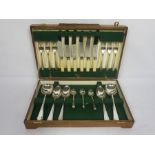 An Art Deco style case of silver plated flatware, for six place settings, with bone handled