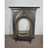 A Victorian style iron fire surround and grate, with arched niche and fern decoration, 102cm high,