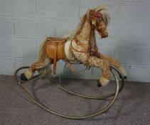 A small vintage child’s Rocking Horse, with tubular frame and saddle, 83cm high, 100cm long