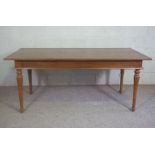 A small dining or kitchen table, 20th century, with a plain rectangular top on four turned and