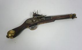 A replica Arabian flintlock pistol, with brass pommel, hinged plunger, hexagonal barrel, 45cm long