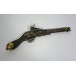 A replica Arabian flintlock pistol, with brass pommel, hinged plunger, hexagonal barrel, 45cm long