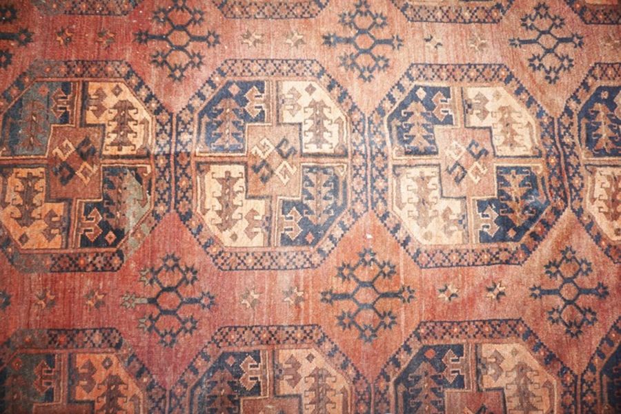 A Turkmen Tekke rug, early 20th century, decorated with three lines of guls on a brown ground within - Image 2 of 3