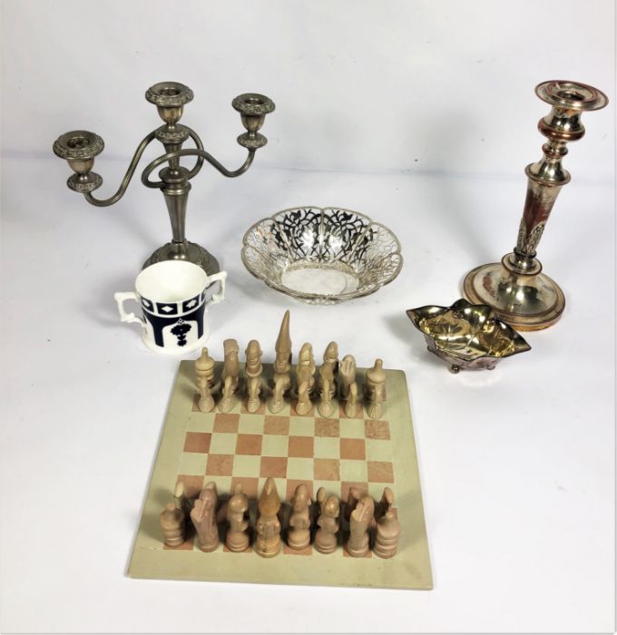 A vintage stone chess set, including board; together with a silver plated candle stick, plated