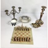 A vintage stone chess set, including board; together with a silver plated candle stick, plated