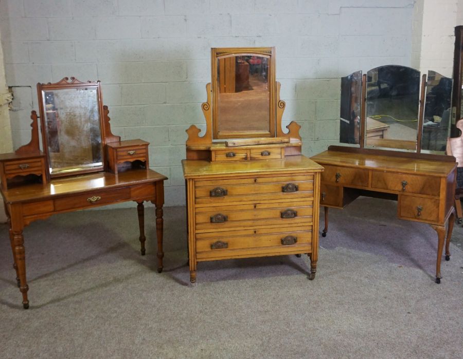 An Edwardian walnut dressing table, circa 1901, with an oval hinged mirror and arrangement of
