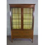 An Edwardian mahogany and satinwood cross-banded china cabinet, circa 1910, with two glazed doors,