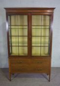 An Edwardian mahogany and satinwood cross-banded china cabinet, circa 1910, with two glazed doors,