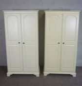A pair of modern white painted wardrobes, each with two panelled doors, 187cm high, 85cm wide