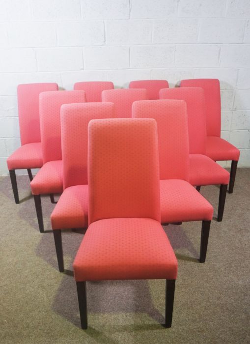 A set of ten modern beech framed dining chairs, with scrolled over and upholstered backs,