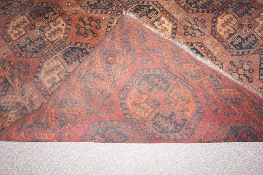 A Turkmen Tekke rug, early 20th century, decorated with three lines of guls on a brown ground within - Image 3 of 3