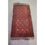 Four small decorative rugs, including a modern Tekke style prayer rug, 100cm x 50cm; together with