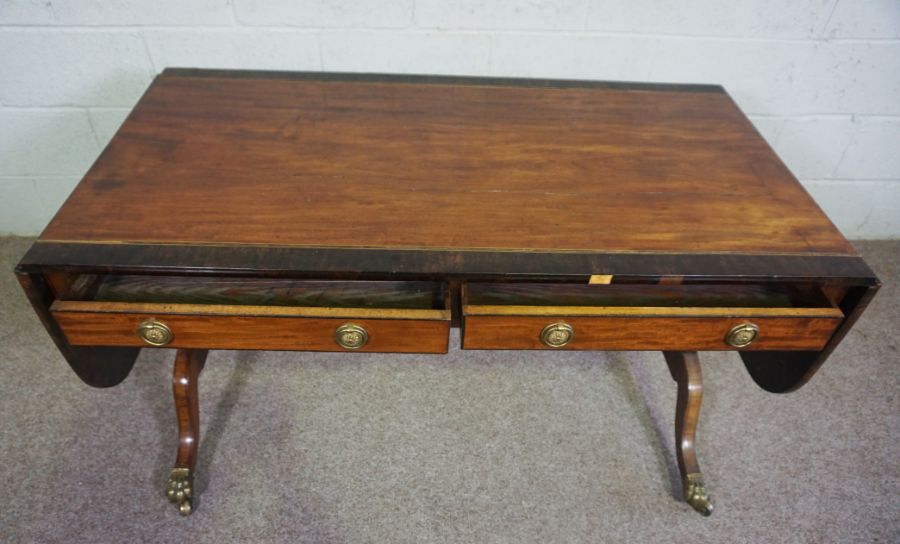 A Regency mahogany sofa table, circa 1810, with a drop leaf cross-banded top, over two drawers and - Image 6 of 6