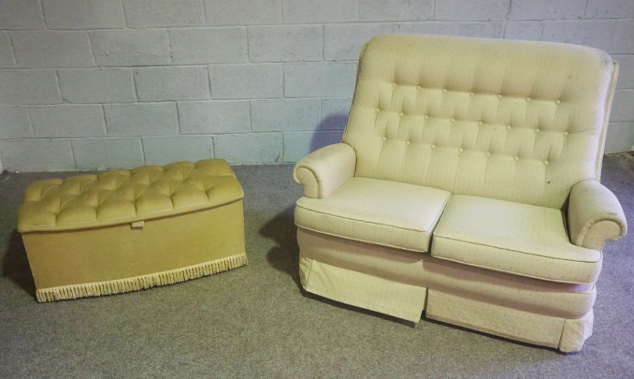 A modern two seat sofa, with beige upholstery, together with a small upholstered ottoman (2)