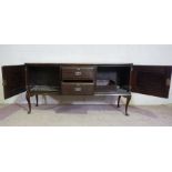 An Edwardian walnut dresser base, circa 1910, with two central drawers flanked by cabinets, 90cm