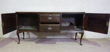 An Edwardian walnut dresser base, circa 1910, with two central drawers flanked by cabinets, 90cm