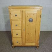 A French vintage pine cabinet, with four small drawers, 136cm high, 89cm wide