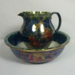 A group of Maling lustre ware, including a large jug and basin, decorated with fruit, a ginger jar