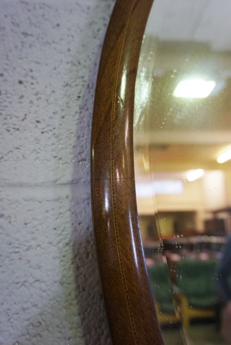 An Edwardian oval mirror on stand, with curved supports, 73cm high, 82cm wide; and another oval - Image 4 of 10