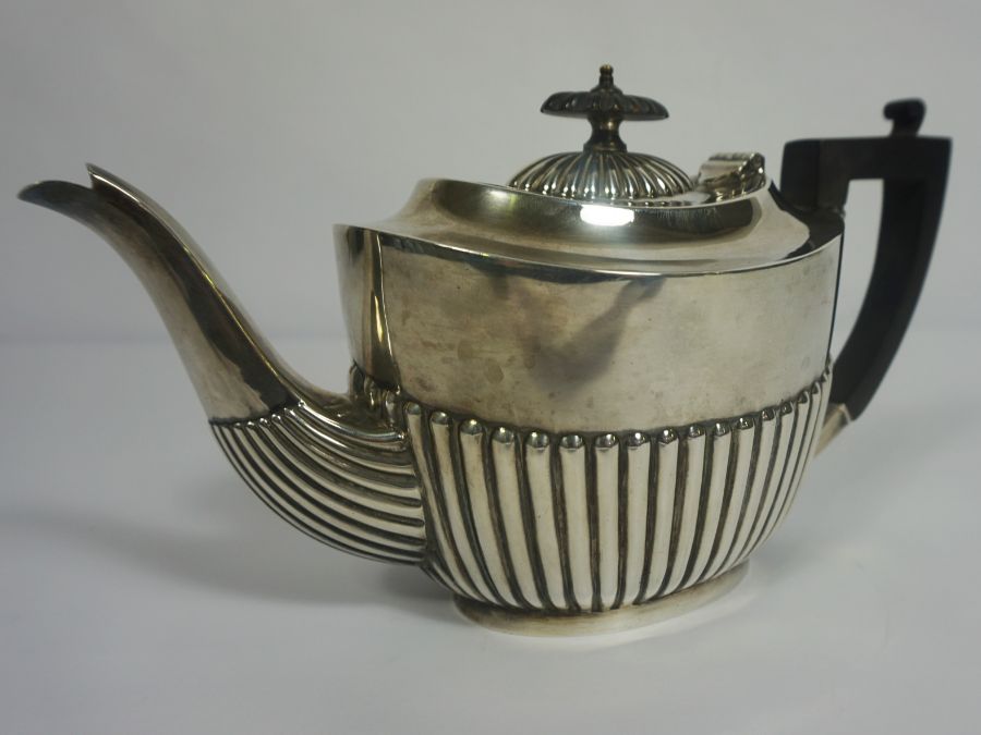 An Edwardian silver teapot, hallmarked Sheffield 1905, of oval part fluted form, with ebonized - Image 3 of 6