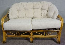 A modern Wicker colonial style settee, with cushioned back, 120cm long