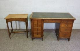 A vintage oak desk, early 20th century, with arrangement of drawers and a cupboard, 77cm high, 124cm