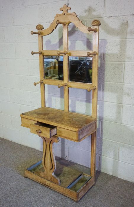 A late Victorian oak hall stand, circa 1900, with an arched top, with nine hat hooks over a small - Image 3 of 4