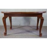 A large oak framed extending dining table, with single leaf, on cabriole legs, 76cm high, 194cm long
