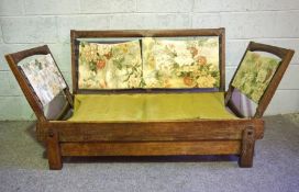 A vintage Parker Knoll oak framed adjustable settee, circa 1940-50, with unusual slide out sides and