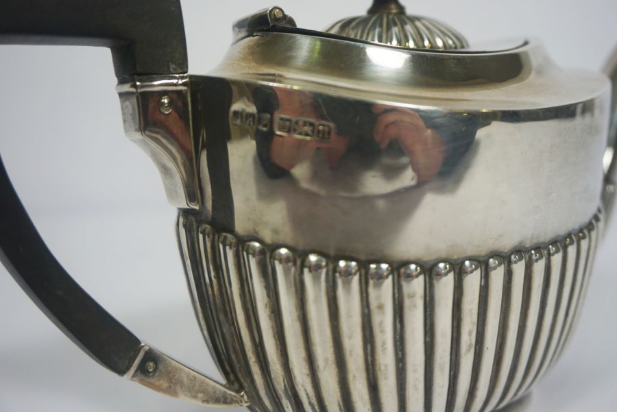 An Edwardian silver teapot, hallmarked Sheffield 1905, of oval part fluted form, with ebonized - Image 5 of 6