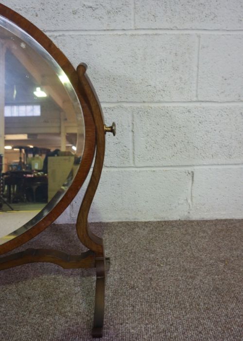 An Edwardian oval mirror on stand, with curved supports, 73cm high, 82cm wide; and another oval - Image 9 of 10