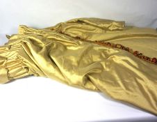 A pair of ‘antique gold silk’ style curtains, with heavy interlining and multi-colour tasselled