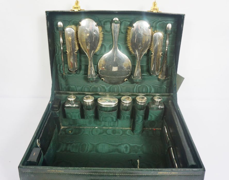 A fine Edwardian Walker & Hall green Morocco leather travelling vanity case, including six silver