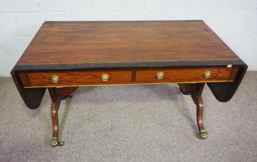 A Regency mahogany sofa table, circa 1810, with a drop leaf cross-banded top, over two drawers and - Image 4 of 6