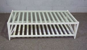 A large modern white coffee table, with lattice magazine under tier and glass top, 43cm high,