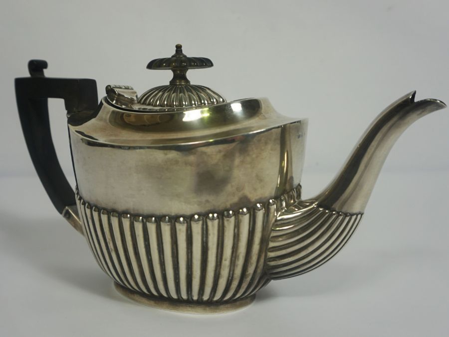 An Edwardian silver teapot, hallmarked Sheffield 1905, of oval part fluted form, with ebonized - Image 2 of 6