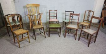 An assortment of ten chairs, including a vintage country style rocking chair; an oak bow framed desk
