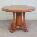 A Victorian style hardwood circular hall table, modern, with a moulded circular top on a heavy