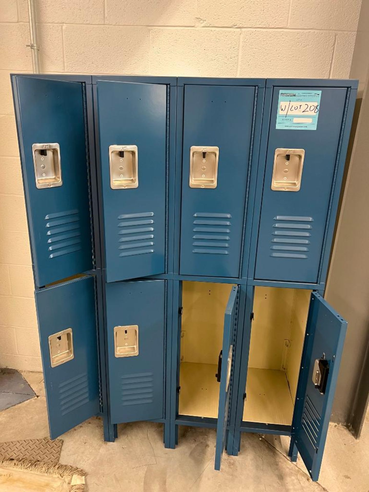 Two banks of 8 blue, pad lockable, half height lockers. Sixteen total lockers.
