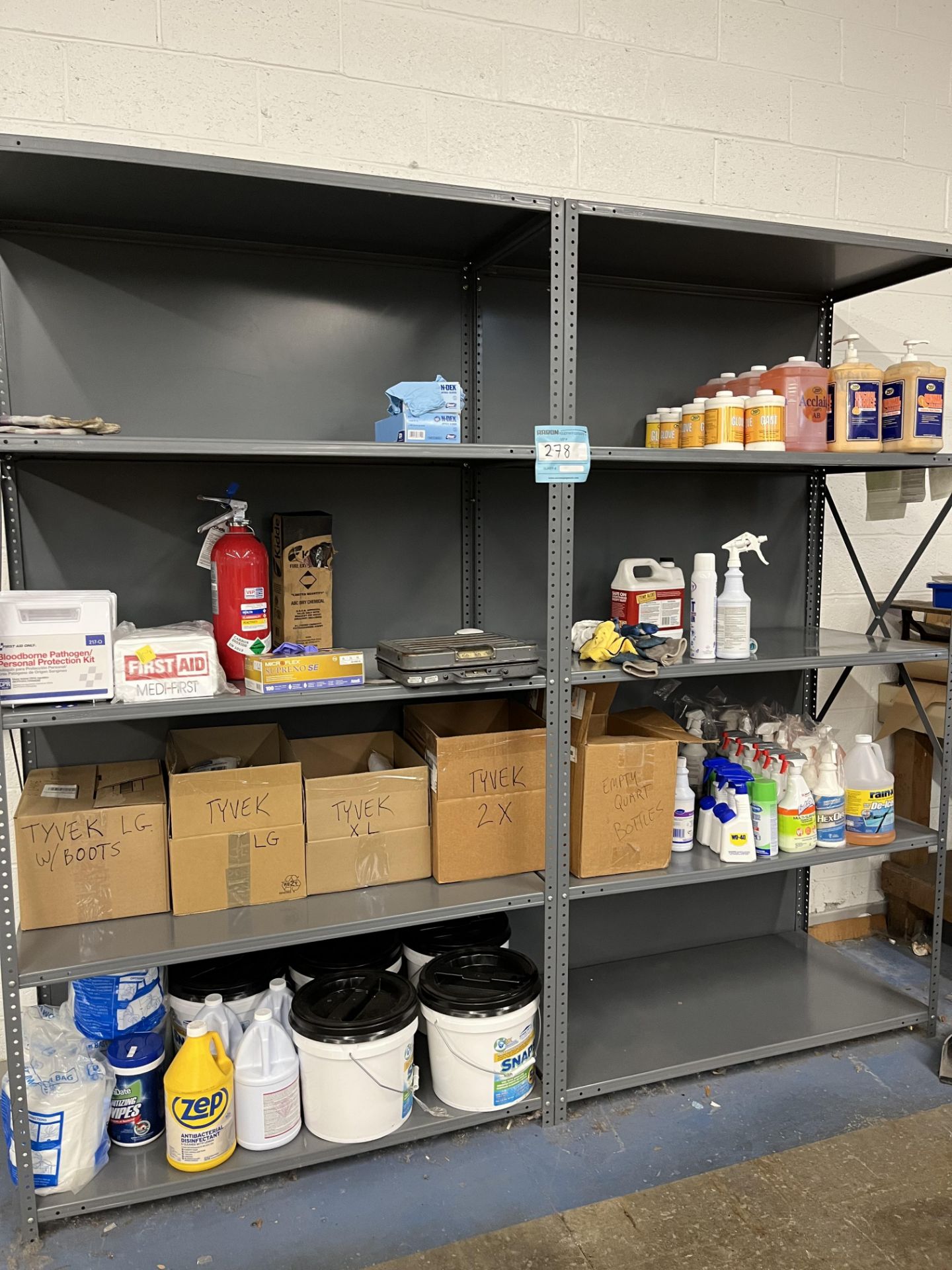 LOT: Rack, Cleaning products, tyvek suit, first aid kits