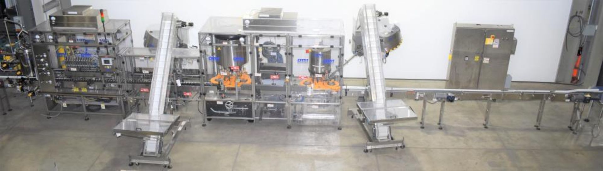 Used- DTM Purefill 2000 Liquid Filling Line with Garvey Feed Table. Pneumatic Scale Model PSC8 plugg