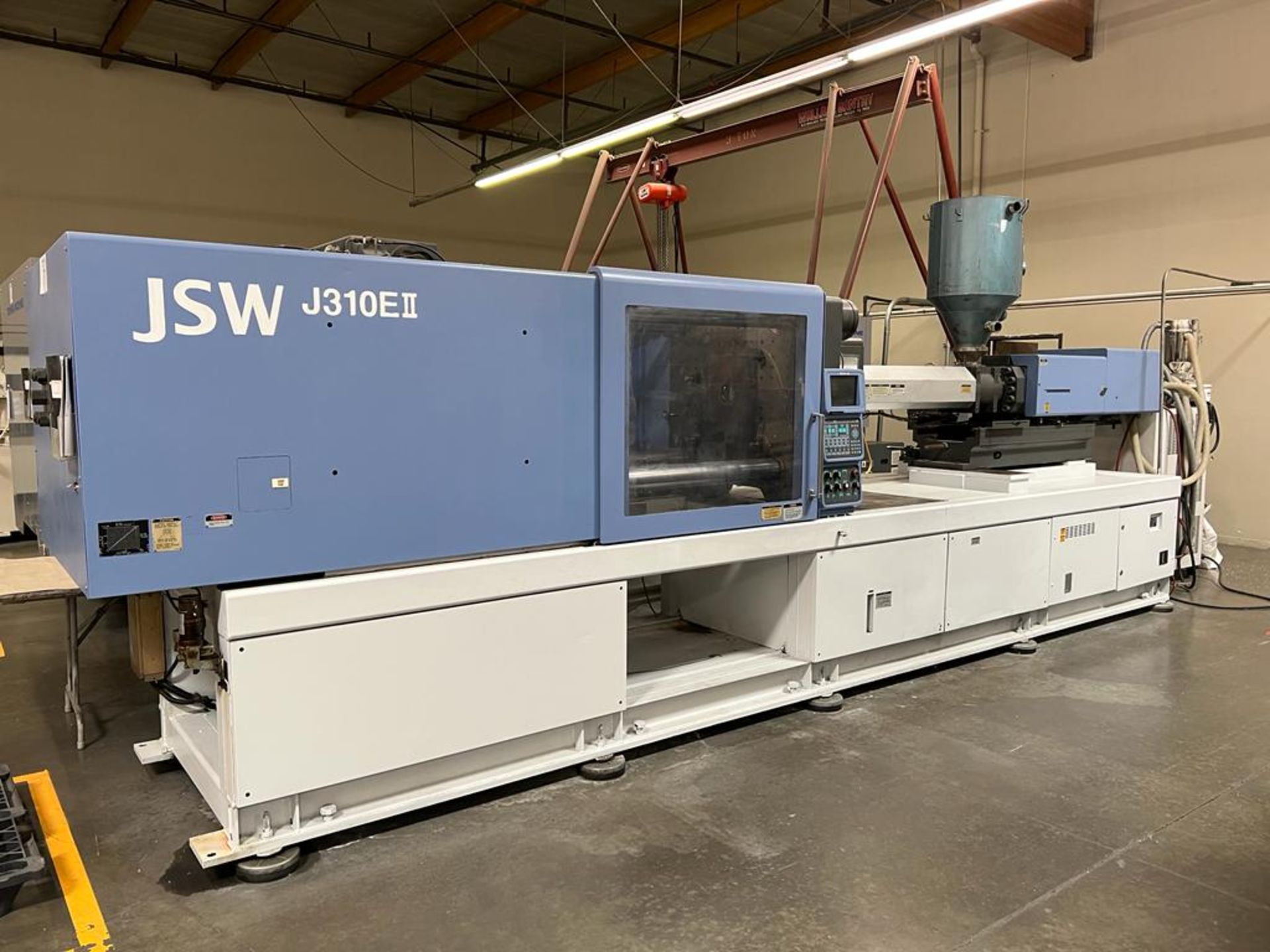 JSW MODEL 310E II, 310 TON PLASTIC INJECTION MOLDING MACHINE, 22.44’’, 64.69 Shot Size. SOLD AS-IS