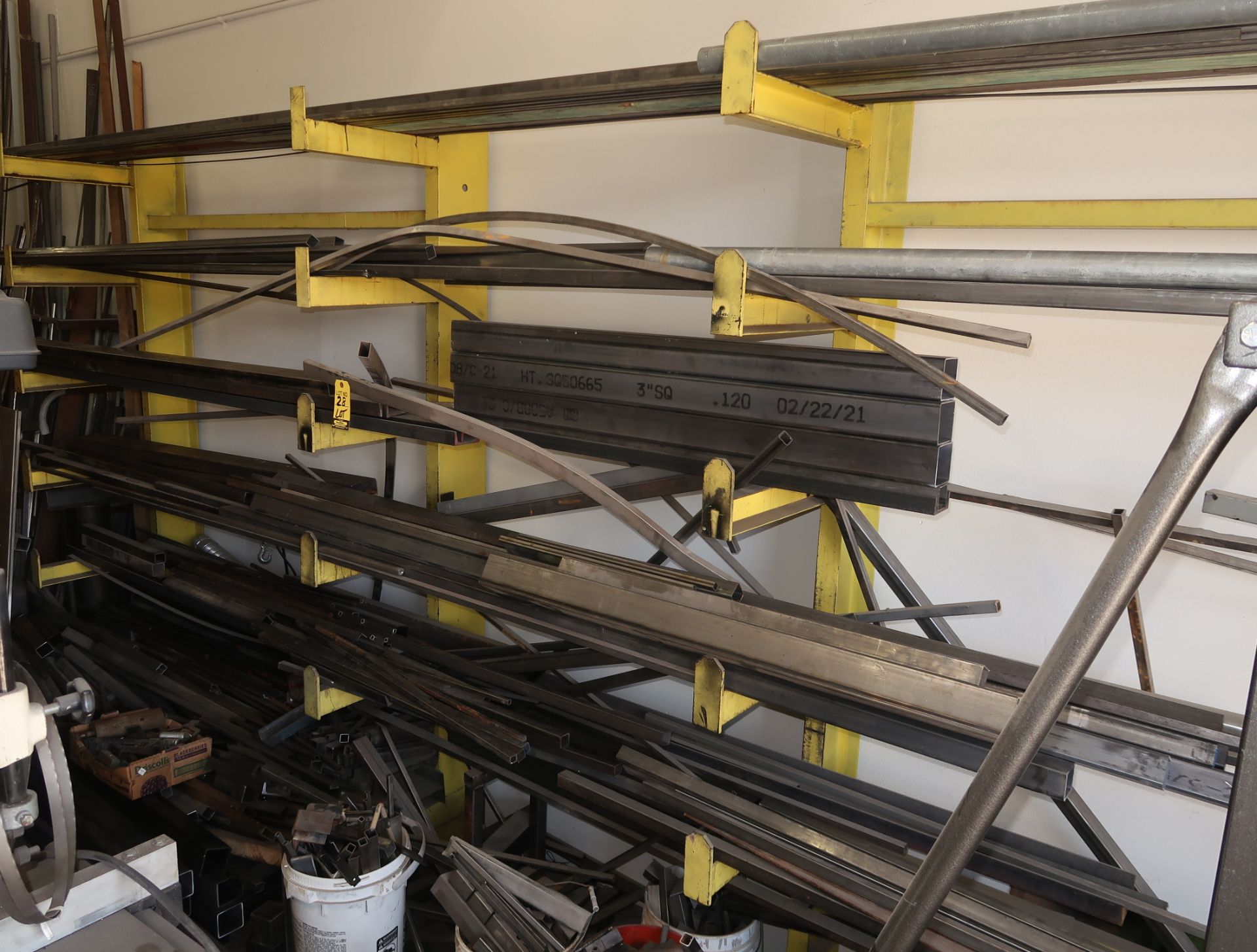 LOT ASST STEEL MATERIAL ALONG WALL, ON RACK, INCLUDES (2) 6'X8' CANTILEVER RACKS 1-VERTICAL RACK