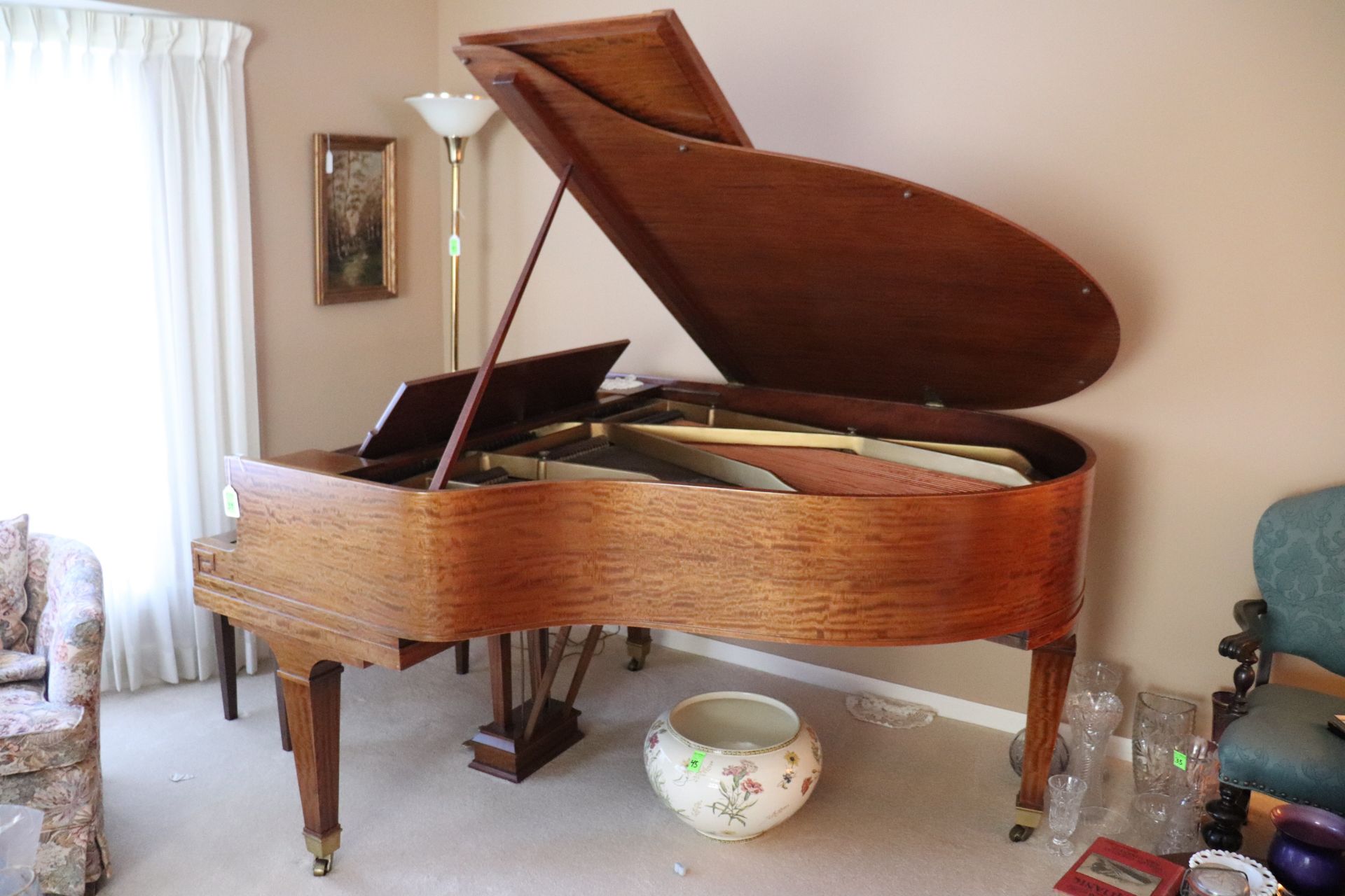 Krakauer baby grand piano contained in a mahogany case complete with bench, approximate height 39",